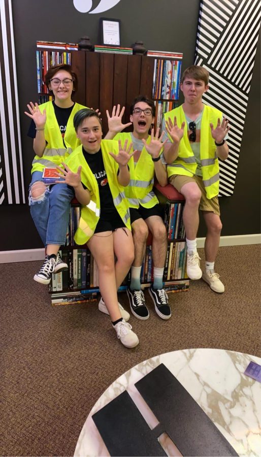 Students Liz Hayes, Alix Queen, Jayce Haun and Rhett Cunningham all pose in yellow vest for their picture while at Herff Jones Planation for a field trip.