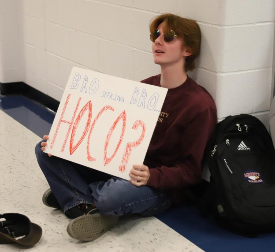 Connor Higlen in the 500 hall holds up his unique sign.