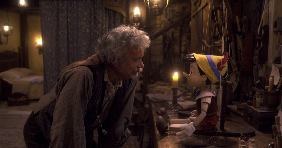 Geppetto+%28Tom+Hanks%29+stares+intently+at+Pinocchio+in+Disneys+live-action+film.