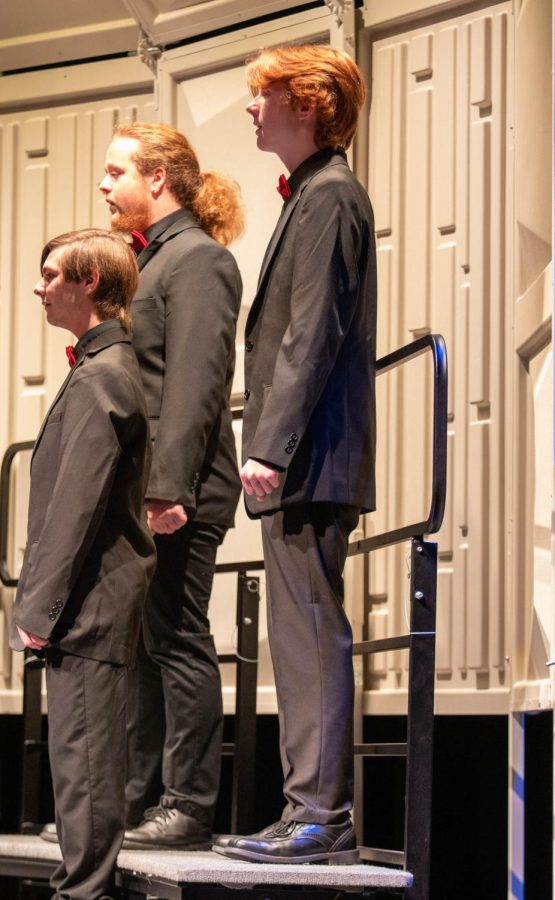 Junior Connor Higlin (right) performs with the chamber choir in the first concert of the year.