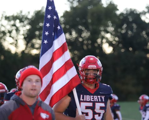Libertys Matt Craig (12), carries flag to show appreciation to our veterans.