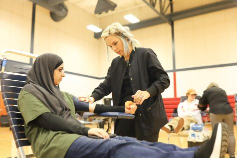 Jeneen Awadallah (12) gets her blood drawn by ImpactLife phlebotomist, Kristin Stanley, during the fall blood drive that took place on Tuesday, Oct. 11. 