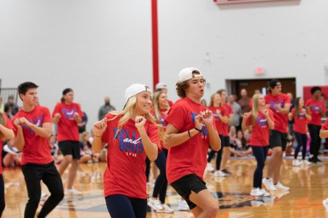 Junior Jenna Handlan and ___ ___ dance together during the Homecoming assembly for a performance of Bells and Bros.  