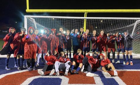 The boys varsity soccer team poses together while holding up No. 1s after their game against Washington.