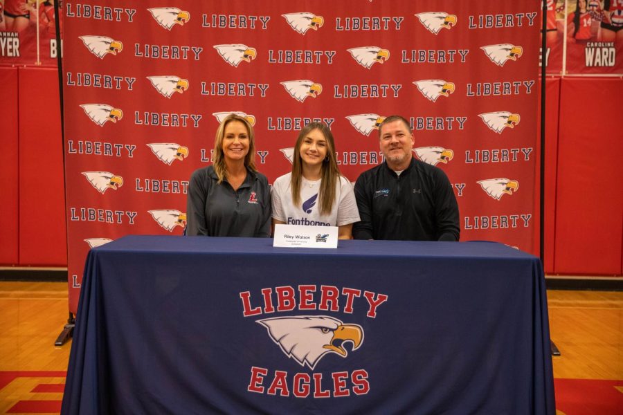 Volleyball player Riley Watson poses with her coaches. Watson has committed to Fontbonne University.
