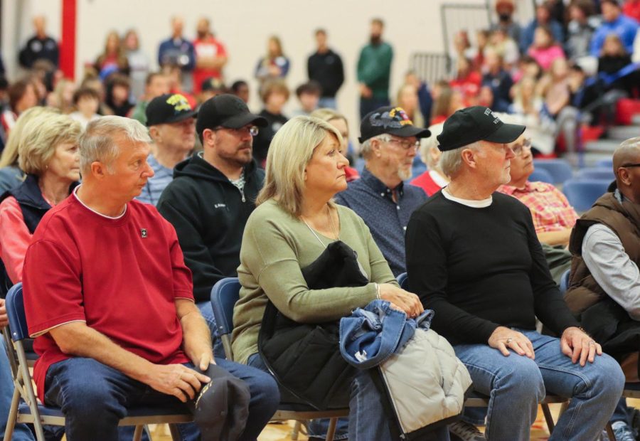 Veterans sit together accompanied by family members at the assembly. Every veteran is tied to Liberty in some way whether they be a family member of a student or staff member.