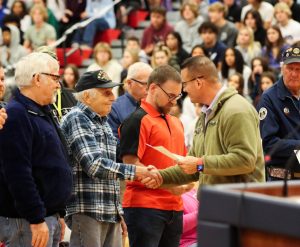 Roughly 35 veterans came to the Veterans Day assembly. Each one was recognized for their service with a certificate handed out by Dr. Nelson. Here, Robert Beager receives his certificate.  