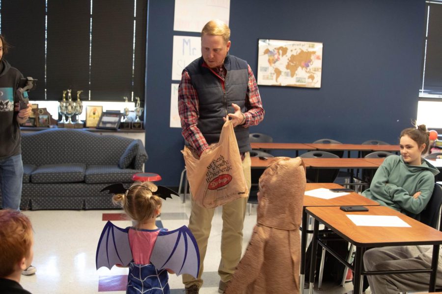 Mr. Cole hands out candy to Eagles Nest preschoolers for their annual trick-or-treat on Oct. 26. 