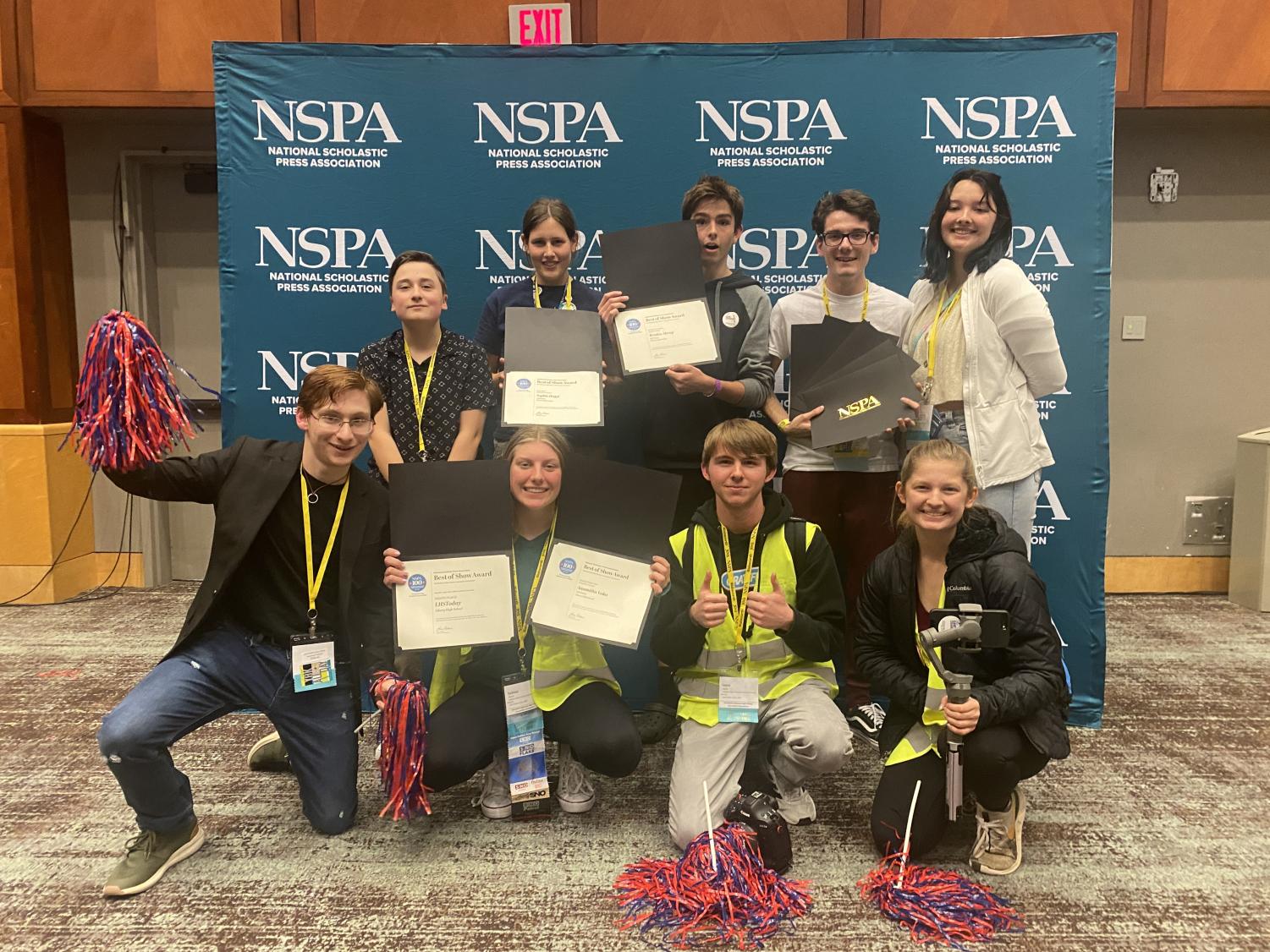 Publications students pose together with nine NSPA awards after the ceremony. 