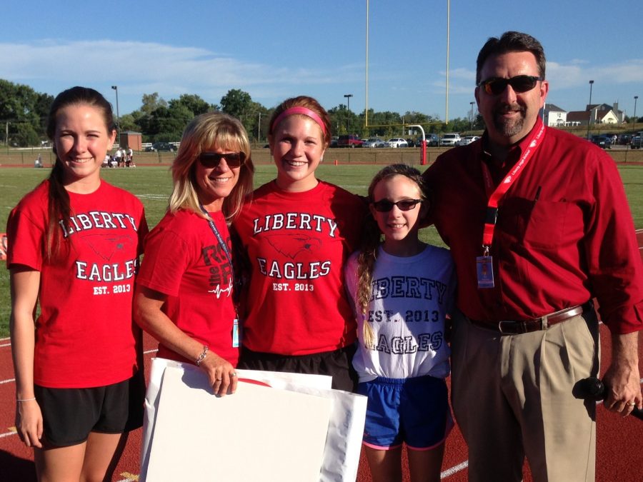 Mr. Phil Ragusky (far right) and his family pose at Libertys first home football game. 