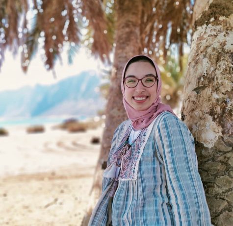 Rodiana Mousa stands on a beach in her home country of Egypt.