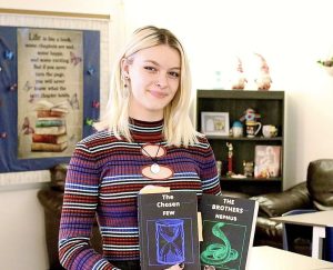 Jennifer Knapp holds her two published books, The Chosen Few, and The Brothers Nephus.