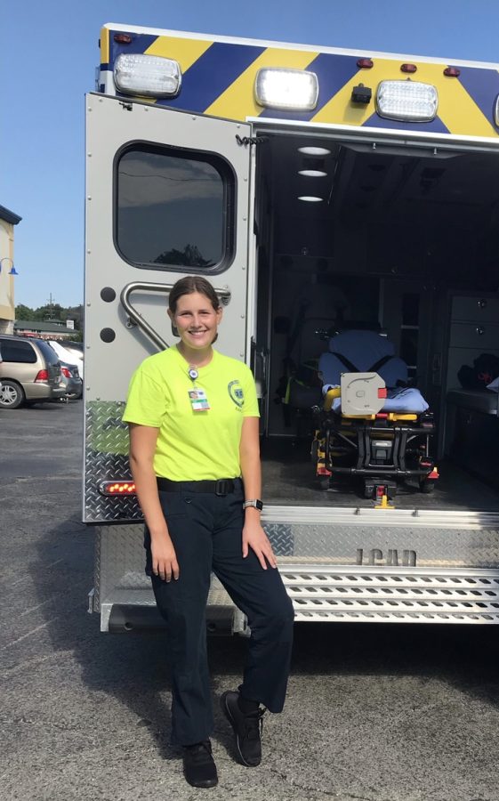 Sophie Heygi stands in her uniform at a back-to-school event where she showed kids the ambulance. 