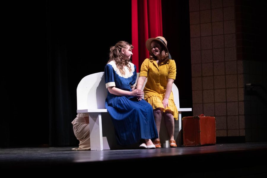 Alice Murphy (played by Anna Wright (12)) and Mama Murphy (played by Elaine Thimyan (12)) hold hands while seated on a bench. In this scene Alice realizes that The Sun is Gonna Shine Again.
