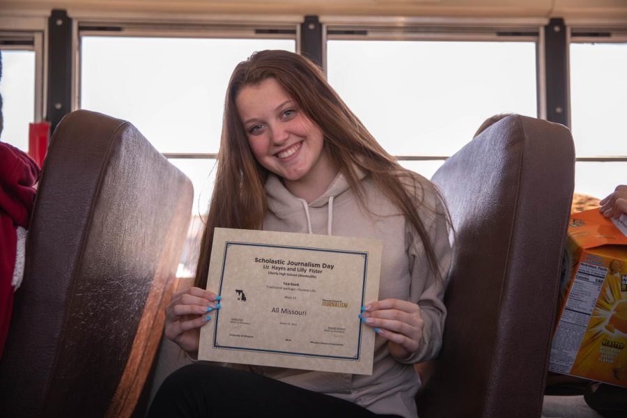 Lilly Fister holds her All-Missouri award for yearbook from J-Day after the ceremony.