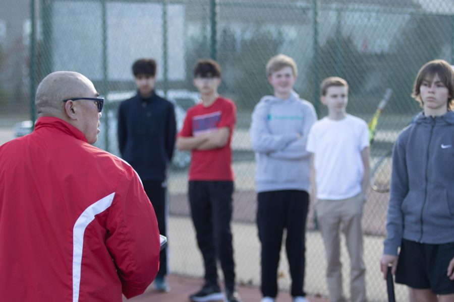 Coach Campos talks to the boys tennis athletes.