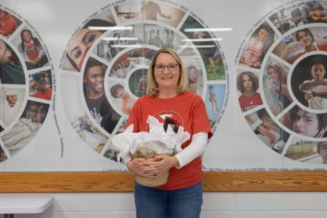 Ms. Lisa Berghoff poses with her celebratory gift basket after winning Support Staff Member of the Year. 