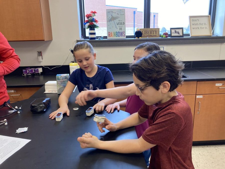 In one of the stations, the students learned about pulse oximeters and how to read them. Here the students were taking their own pulse ox levels. 