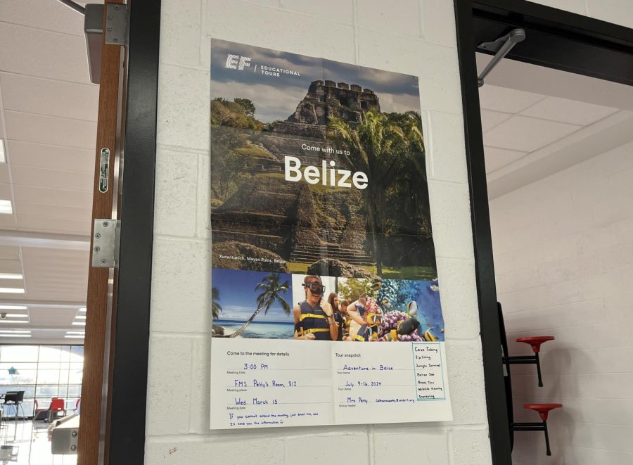 A sign advertises Adventure in Belize in the upstairs space between the 200 and 400 hallways. 