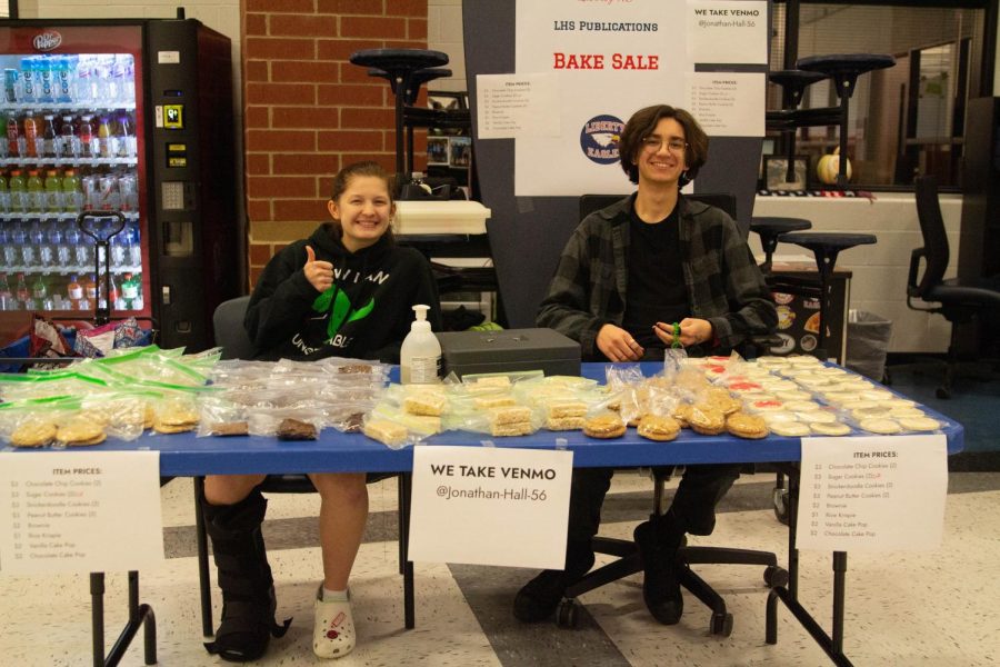 Megan Geisler (11) and Landon Woodson (11) run the publications bake sale funding their spring trip to San Francisco. 