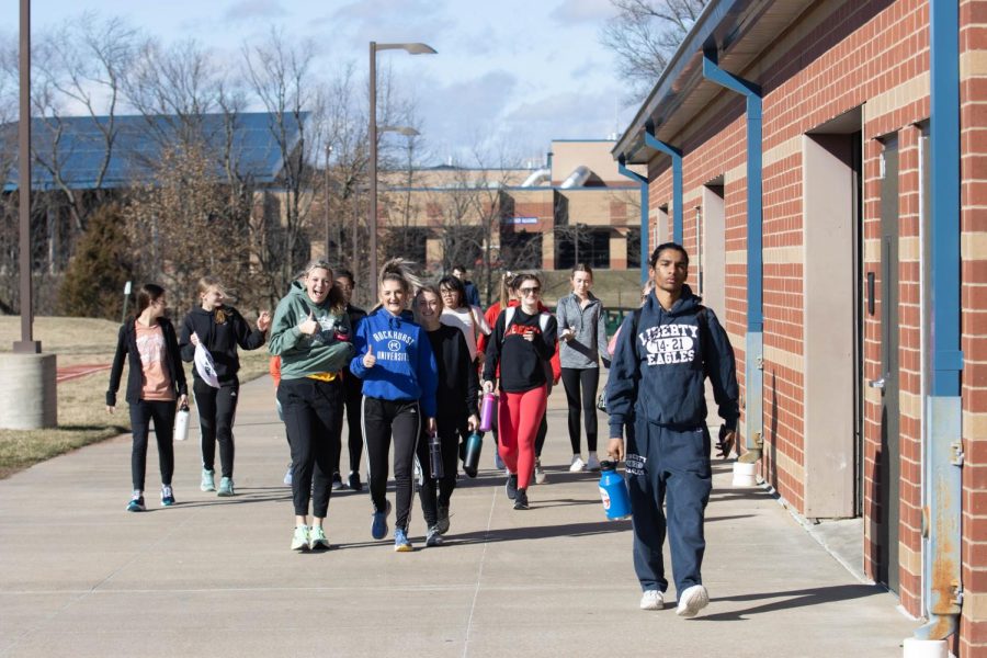 Track athletes pose as they walk to tryouts.