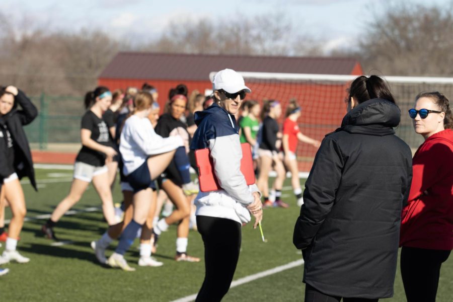 Varsity girls soccer coach, Coach Kleekamp, talks to other soccer coaches.