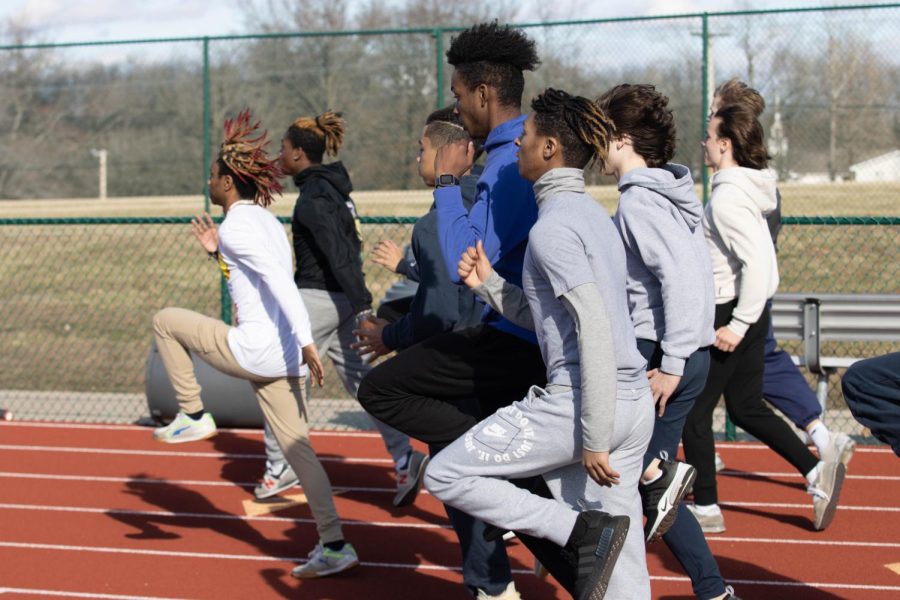 The boys track team warms up for tryouts.