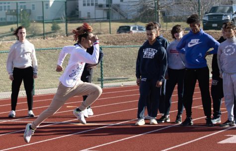 Junior Courtney Jefferson works on his sprint mechanics in an explosive start on the first day of track practice on Feb. 27.  Track athletes spent their first day outside practicing drills despite the windy conditions.