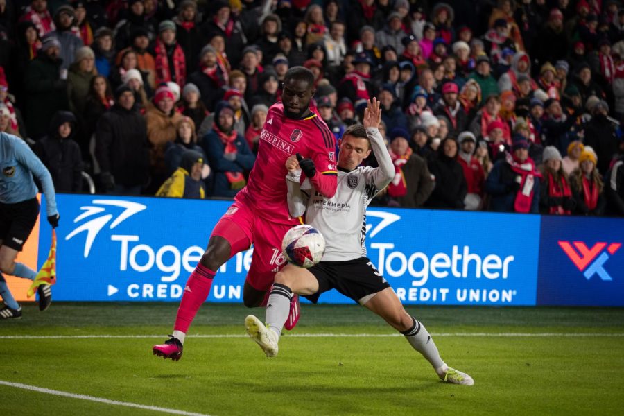 St. Louis CITY SC forward Samuel Adeniran and San Jose Earthquakes defender Paul Marie chase down the ball in an attempt to keep it in bounds.