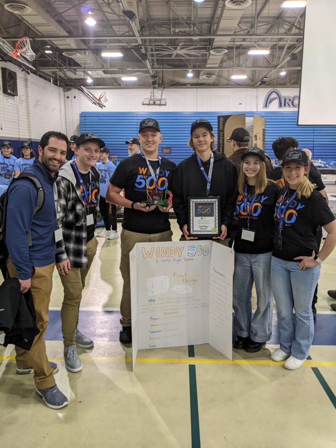 The+PLTW+engineering+team+hold+their+project+and+second+place+trophy.