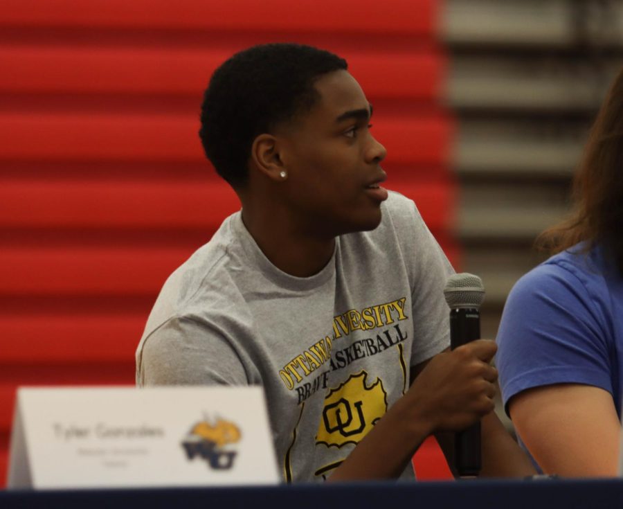 Blake Cunningham listens to a question from Mr. Eldredge during the signing ceremony. 