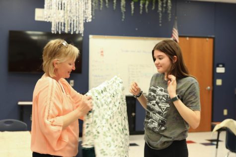 Ms. Langston helps Sara Reth (11) with the quilt. The creative freedom, I got to pick my fabric, the patterns, and in the end I got a really nice warm blanket to take home, Reth said.