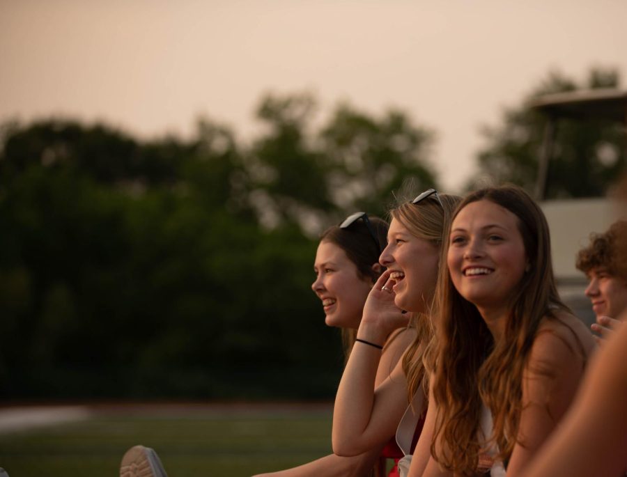 Seniors+Serena+Bartles%2C+Anna+Hillgartner+and+Ava+Swift+sit+on+the+football+field+and+watch+the+sun+set+during+the+annual+Senior+Sunset.