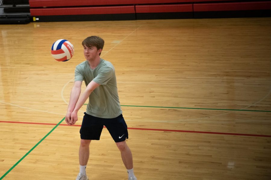 Jayce Haun (12) bumps a volleyball while playing a game in the gym.