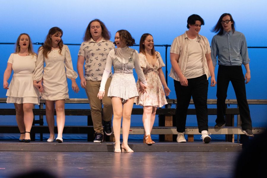 Seniors (left to right) Payton Busselman, Elaine Thimyan, Shane Wolz, Morgan Feinstein, Anna Wright, Logan Honerkamp, and Cade Goins perform their group number So Long, Farewell from The Sound of Music.
