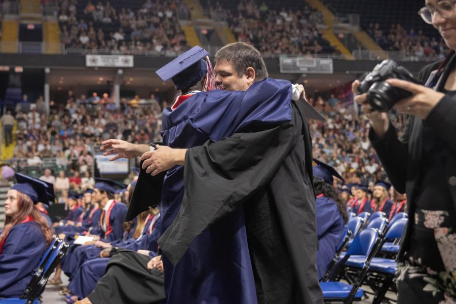 Rhett Cunningham hugs his father, counselor Chad Cunningham, during the graduation ceremony.