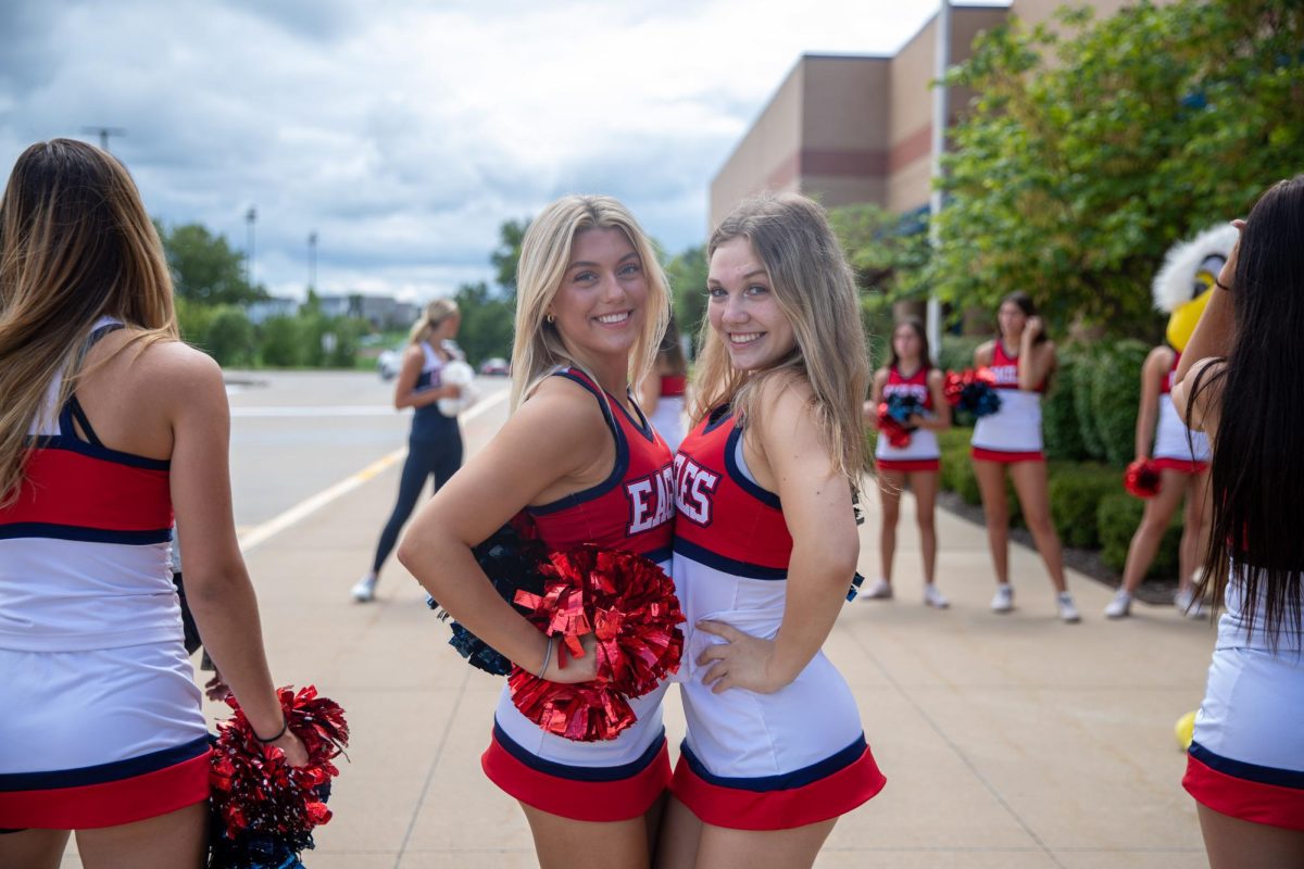 Juniors Addison Sheffield and Holleigh Vohsen pose for a photo while welcoming Wentzville staff into Libertys front entrance. 