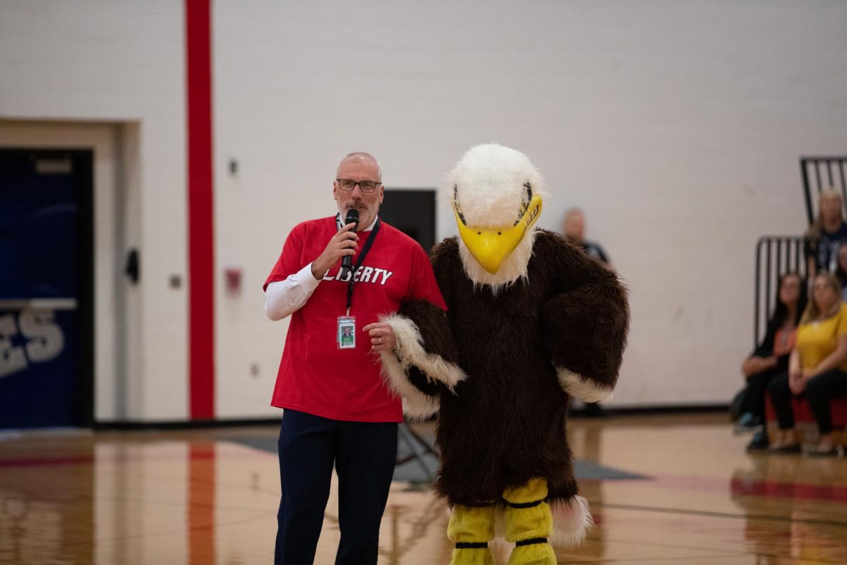 Superintendent of Human Resources Brian Bishop and Eddie the Eagle link arms and present the Wentzville staff in the stands with a challenge of seeing which side could shout the chant Eagle Nation the loudest. 
