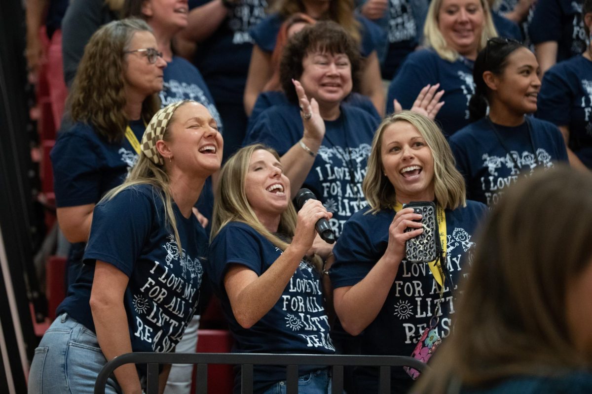 Staff in the Wentzville School District passionately sing along following the lyrics from a projector. 