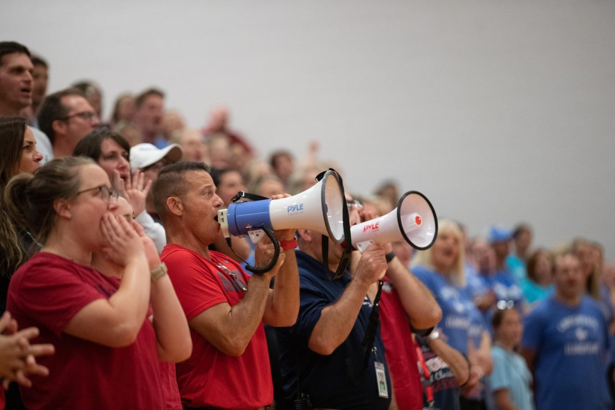 Liberty staff chant We Are proudly hoping to beat the other stands. Dr. Nelson and Mr. Pryor shout into megaphones in hopes of boosting their sides chances of winning. 