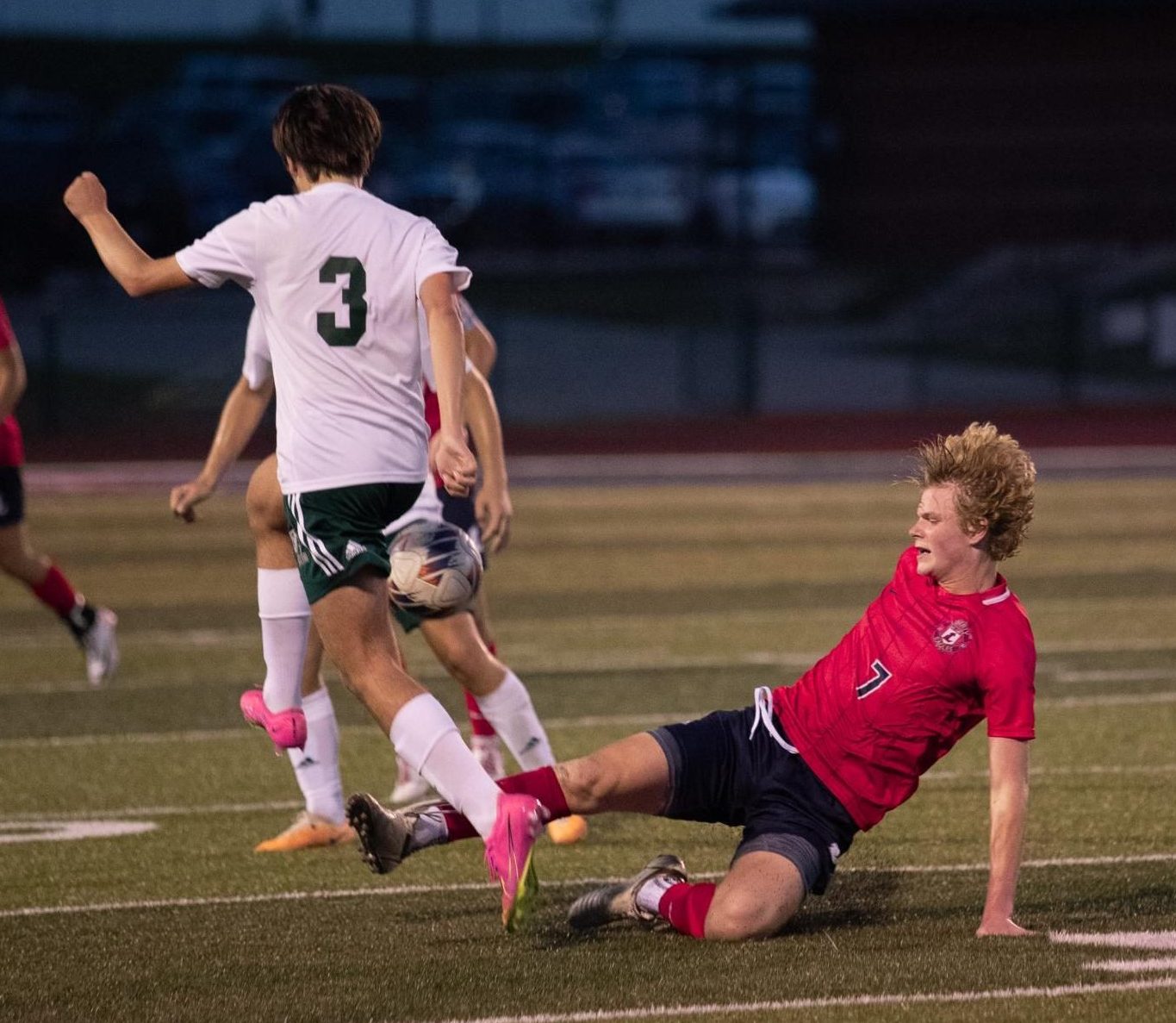 Senior Brady Freeman (#7) slides under a defender hoping to gain possession of the ball.