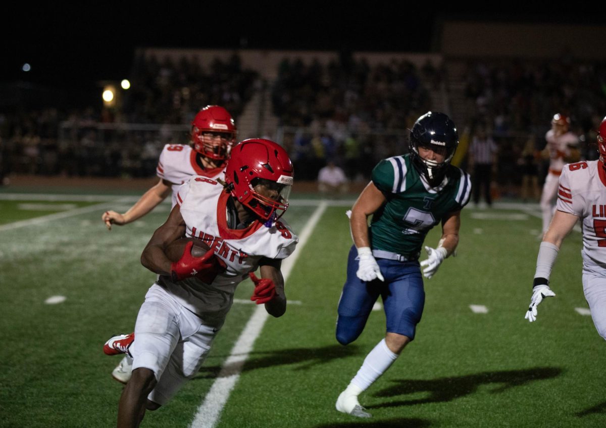 Senior Marquis Williams (#8) runs several yards with the ball, eventually leading to a tackle by Timberlands team.