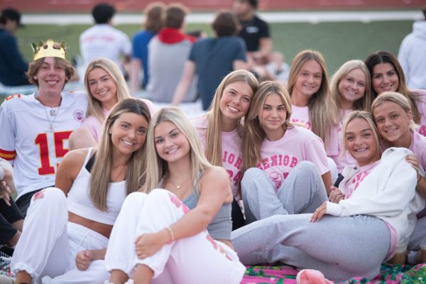 Seniors gather together on the football field to watch the sunrise and start their final year of high school.