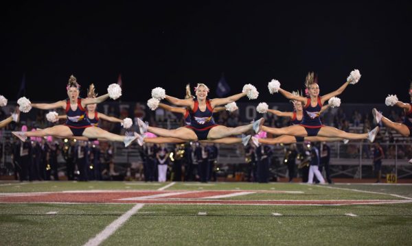 During the final home football game of the season, the varsity Liberty Belles jump into a middle split as a part of their halftime routine.