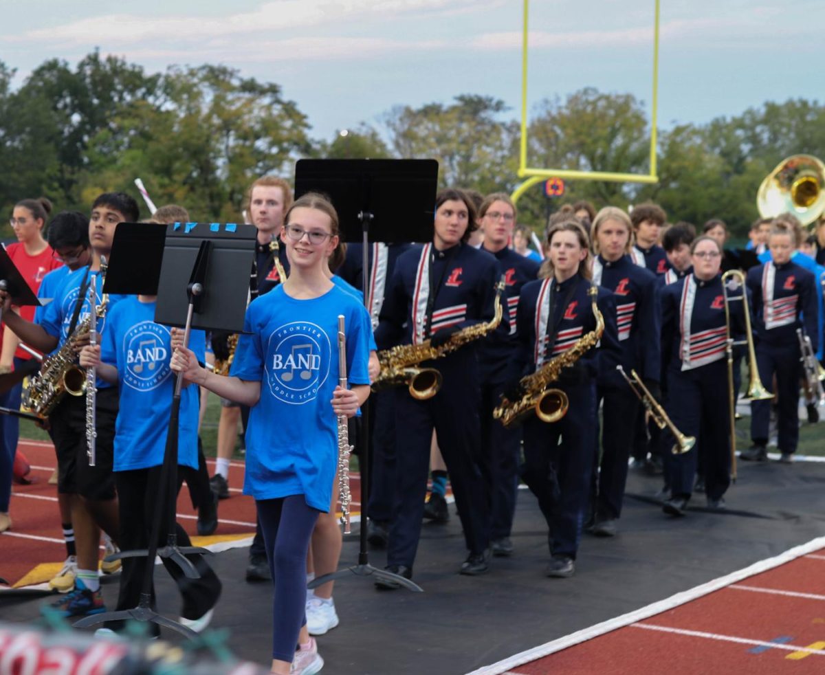 The eighth grade Frontier band marches off the field with the Liberty Regiment.