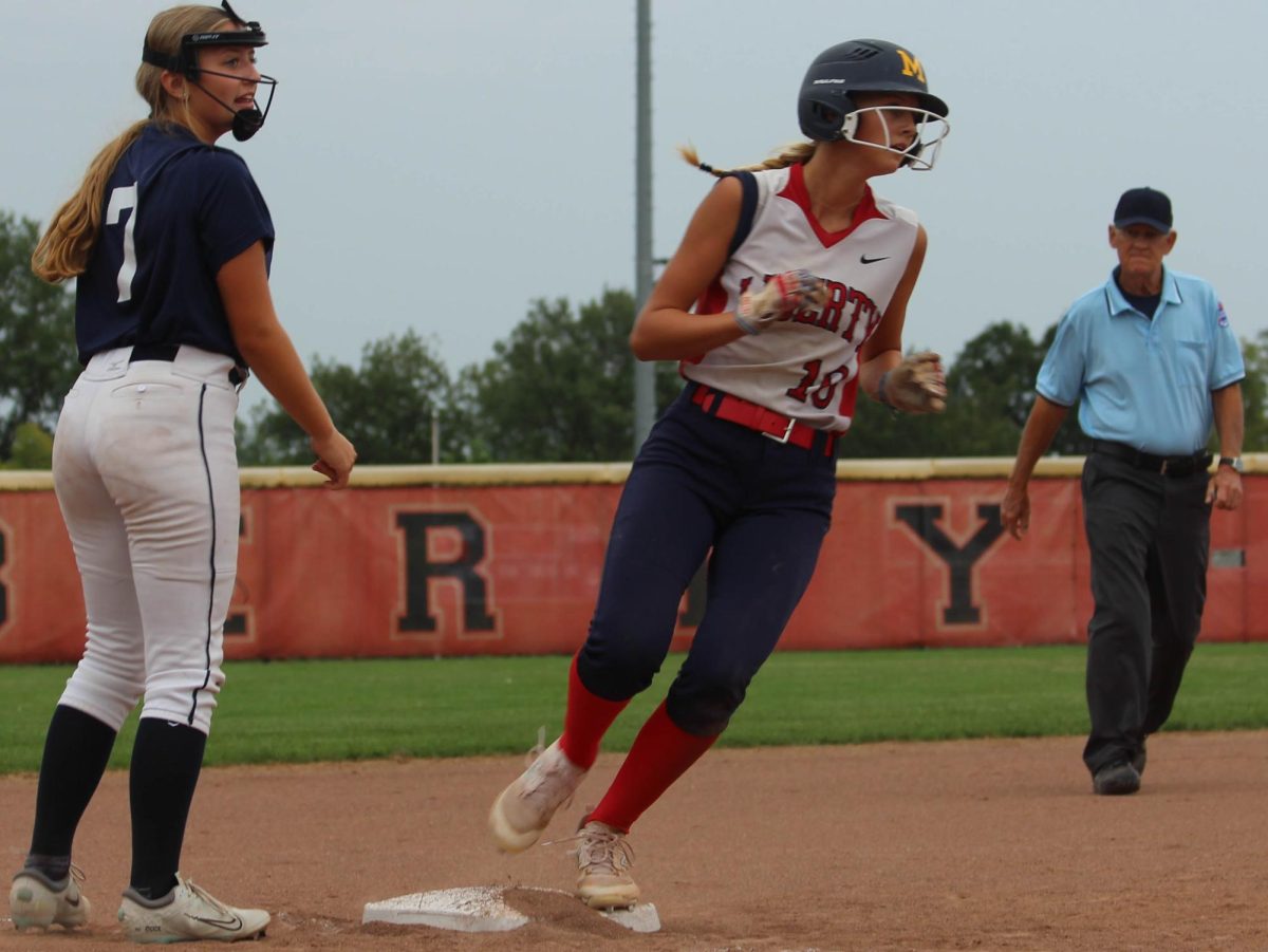 Alli+Moorman+rounds+third+base+sprinting+to+home+plate+to+gain+the+Eagles+with+another+run.
