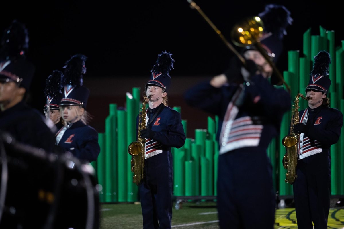 Senior Connor Higlen plays the saxophone during the bands halftime performance. 