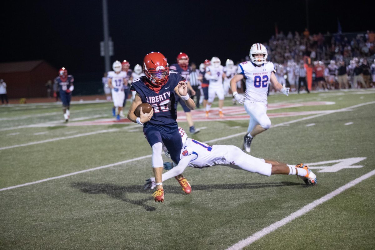 Junior Cody McMullen, representing number 10 on the field, narrowly escapes an attempted tackle.