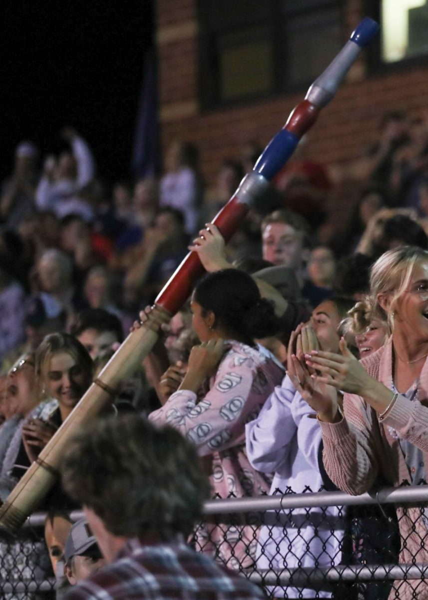 Student section cheers at North Point game with spirit stick 