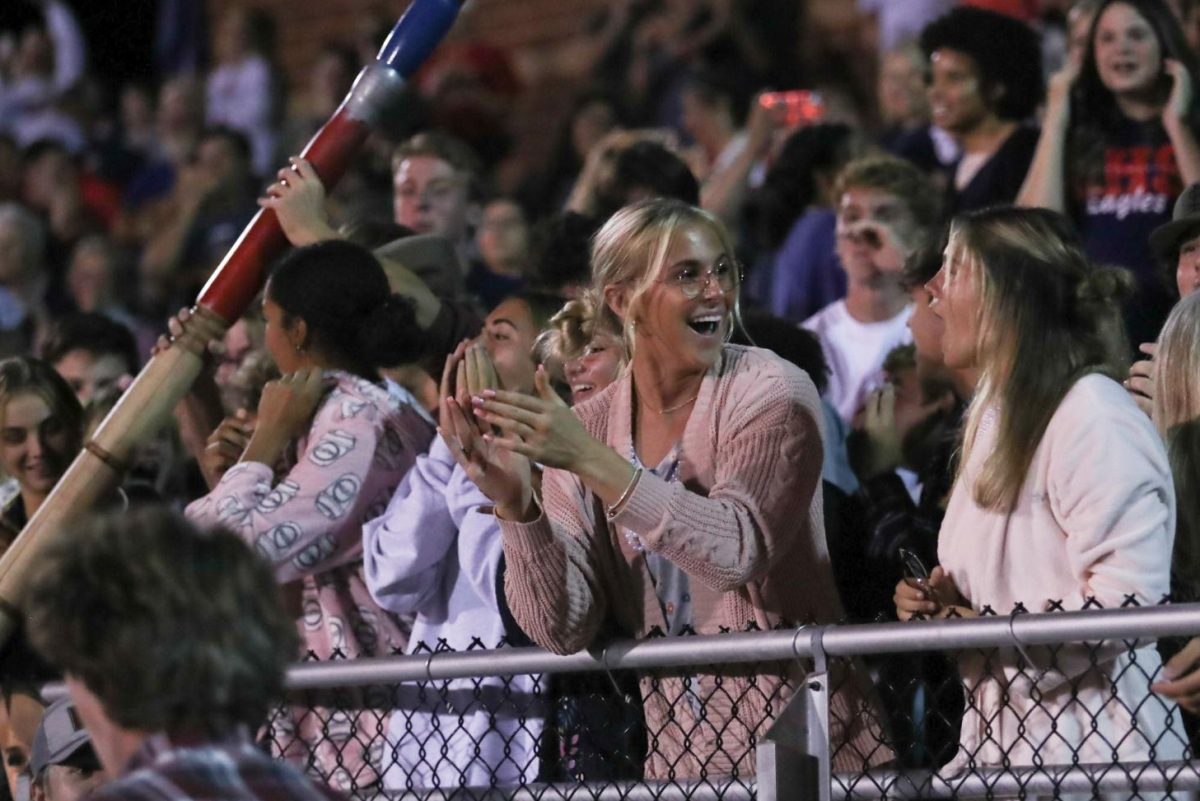 Senior Marley Nelson looks to senior Rainie Corgan, cheering with a shocked expression as Liberty took the win. 